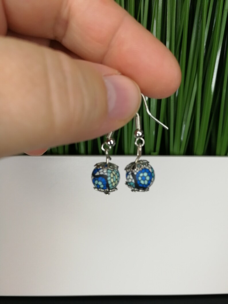 silver earrings with two blue colored pearls