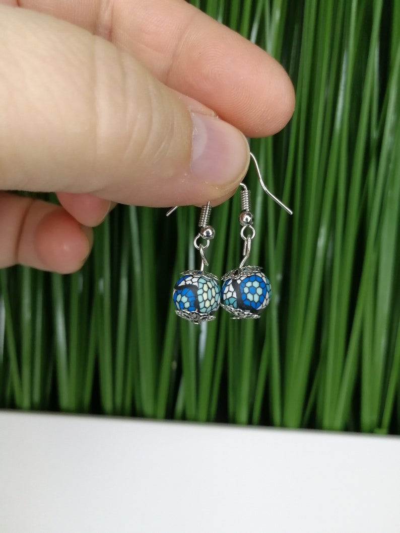 silver earrings with two blue colored pearls