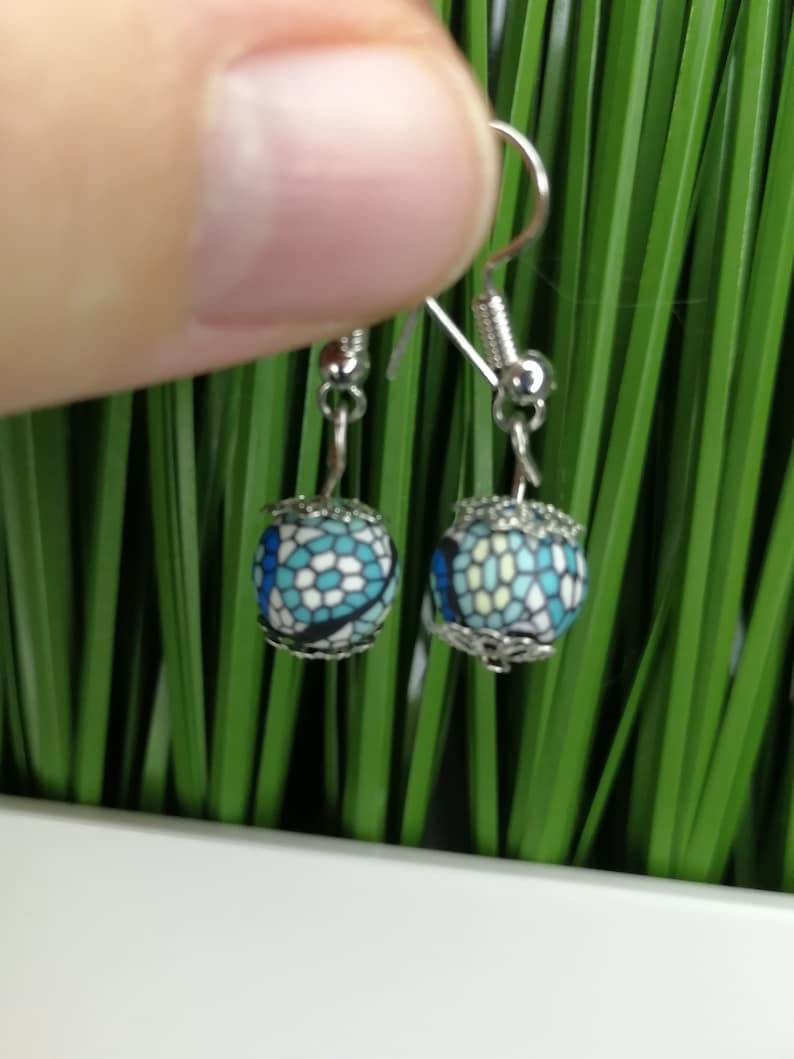 silver earrings with two blue colored pearls