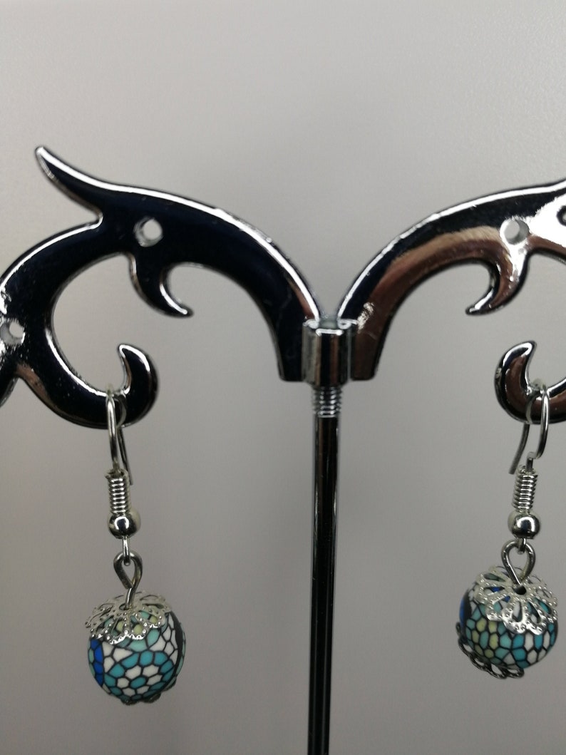 silver earrings with two blue colored pearls