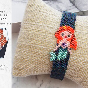 May include: A beaded bracelet with a peyote stitch pattern featuring a mermaid with red hair, a green tail, and a purple seashell. The bracelet is on a light beige fabric background.