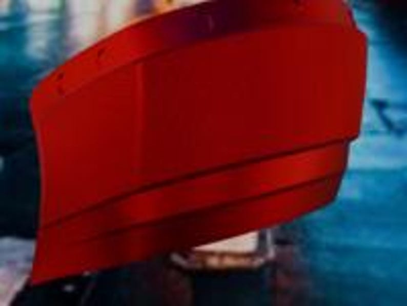 May include: A vibrant red, layered, curved object with a metallic sheen. The object has a smooth, reflective surface and appears to be part of a larger structure. The design features horizontal lines that add depth and dimension.