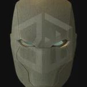 May include: A close-up of a gray, textured mask with a geometric design. The mask has eye openings with a subtle glow. The overall design is angular and modern, with a focus on clean lines and a futuristic aesthetic.