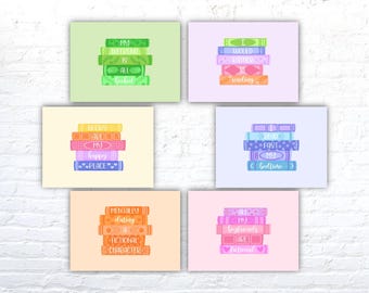 May include: Six printable wall art prints featuring stacks of books with different quotes about reading. The quotes are: "My whole world is all bookish", "I would rather be reading", "Books are my happy place", "I spend most of my bedtime reading", "Mentally dating a fictional character", "All my boyfriends are fictional".