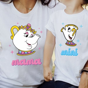 May include: A white t-shirt with a cartoon image of Mrs. Potts from Beauty and the Beast. The shirt says "mama" in pink letters. A smaller white t-shirt with a cartoon image of Chip from Beauty and the Beast. The shirt says "mini" in blue letters.