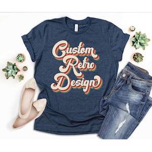 May include: A navy blue t-shirt with a retro-style graphic that says "Custom Retro Design" in a multi-colored font.