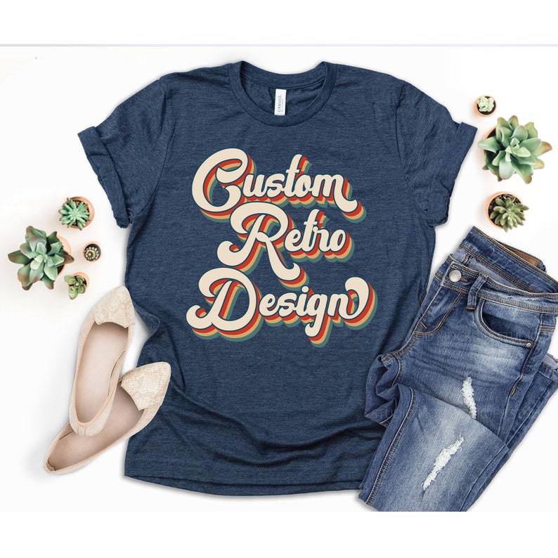 May include: A navy blue t-shirt with a retro-style graphic that says "Custom Retro Design" in a multi-colored font.
