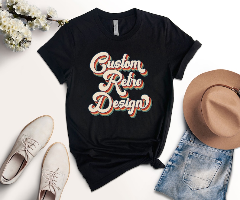 May include: Black t-shirt with a retro-style graphic that says "Custom Retro Design" in colorful, layered letters.