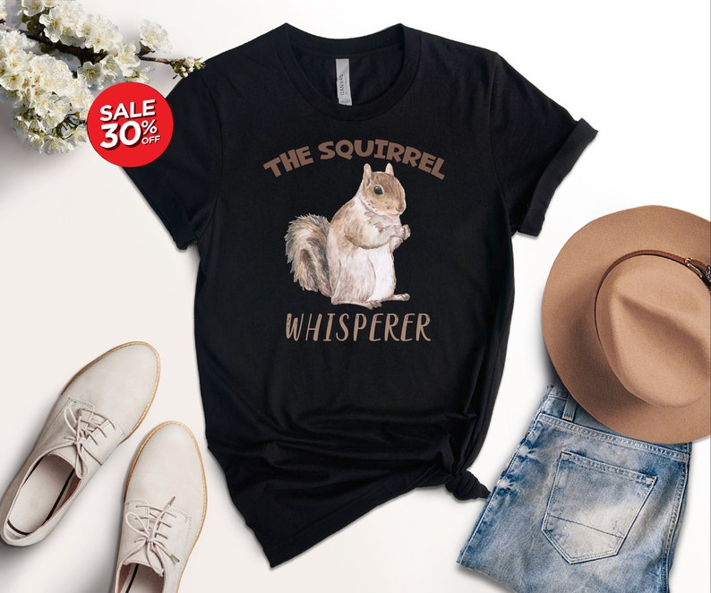 May include: Black t-shirt with a brown squirrel illustration and the text "The Squirrel Whisperer".