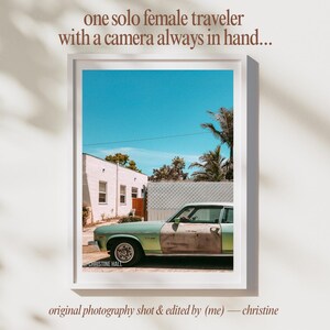 May include: A vintage green car parked in front of a white building with a blue sky and palm trees in the background. The car has rust on the side and the text "CHRISTINE HALL" is visible on the bottom left corner of the image.
