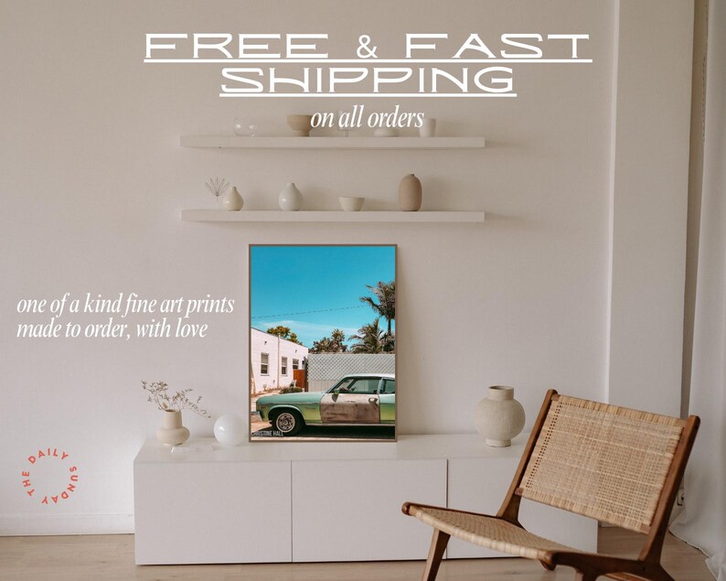 May include: A framed print of a vintage green car parked in front of a building with a blue sky and palm trees in the background. The text "FREE & FAST SHIPPING on all orders" is above the print. The text "one of a kind fine art prints made to order, with love" is below the print. The text "THE DAILY SUNDA" is in a circle in the lower left corner of the image.