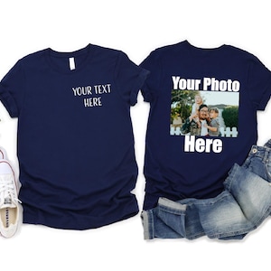 May include: Two navy blue t-shirts, one with the text "Your Text Here" and the other with the text "Your Photo Here" and a photo of a man holding two children.