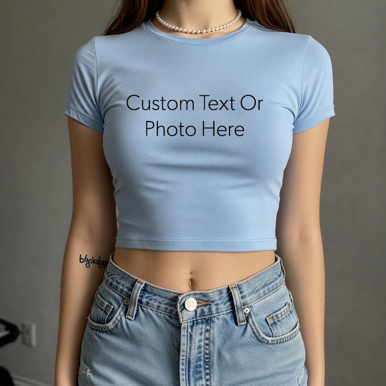a woman wearing a light blue crop top with the words custom text or photo here