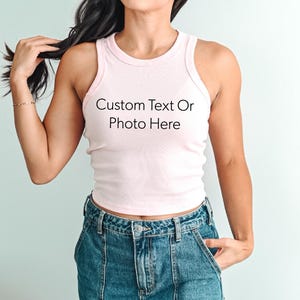 a woman wearing a white tank top with a custom text on it