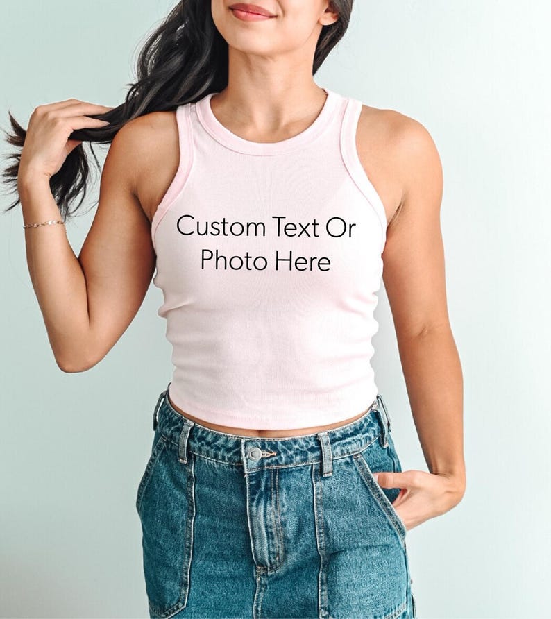 a woman wearing a white tank top with a custom text on it