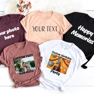 a group of t - shirts sitting on top of a white wooden floor