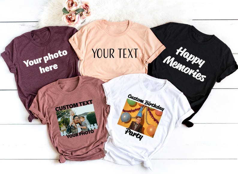 a group of t - shirts sitting on top of a white wooden floor