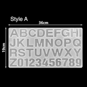 May include: A clear silicone mold for making letters and numbers. The mold is 36 cm wide and 19 cm tall. The mold includes the letters A through Z and the numbers 0 through 9.
