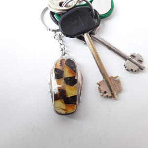 Sleutelhanger Baltisch barnsteen: flesopener met mini-vouwmes