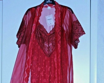 May include: A red sheer robe with lace trim and a matching red lace slip. The robe has short sleeves and a V-neckline. The slip has a V-neckline and is sleeveless. The set is made of a soft, comfortable fabric.