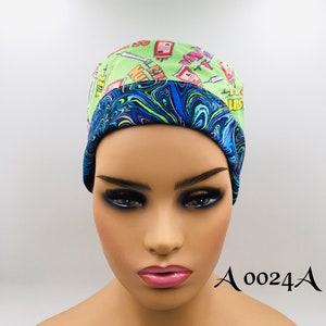 May include: A green and blue surgical scrub hat with a print of syringes and medical equipment. The hat has a blue and purple swirl pattern on the inside.