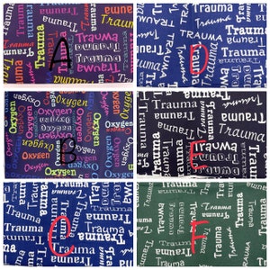 May include: A collage of six fabric squares with different patterns. Each square features a repeated word pattern. The words are "Trauma" and "Oxygen". The squares are arranged in two rows of three. The words are in various colours, including black, white, blue, green, pink, and purple.