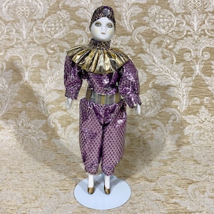 Harlequin Pierrot Clown in Gold and Purple Costume.
