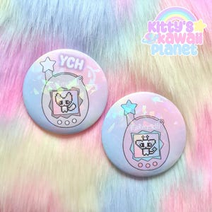 May include: Two iridescent blue and pink button badges featuring a pixelated image of a Tamagotchi pet. The Tamagotchi on the left badge says "YCH" and the Tamagotchi on the right badge says "Furrygotchi".