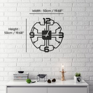 May include: Black metal wall clock with a circuit board design. The clock is 19.68 inches in diameter and features a white clock hand.