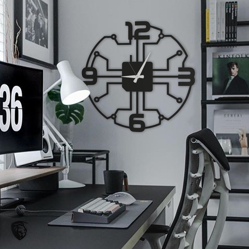 May include: Black and white clock with a circuit board design. The clock has a white background and black numbers. The clock is hanging on a white wall in a home office.