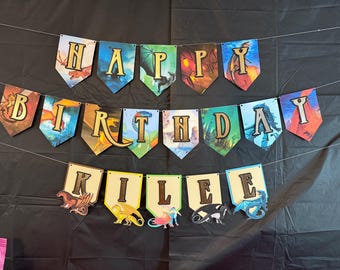 May include: A colorful banner with dragons and the words "Happy Birthday Kilee".