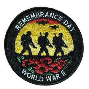 May include: A circular patch with the text "Remembrance Day World War II". The patch features silhouettes of soldiers marching, red poppies, and a yellow and orange background with two airplanes.