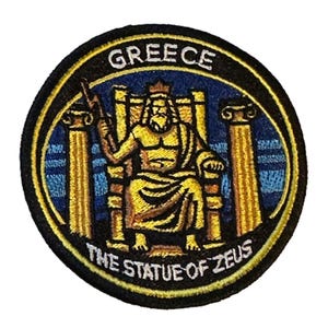 May include: Round embroidered patch featuring the Statue of Zeus, with the word "GREECE" at the top. The statue is depicted in gold, seated on a throne, with the text "THE STATUE OF ZEUS" at the bottom. The patch has a black border.