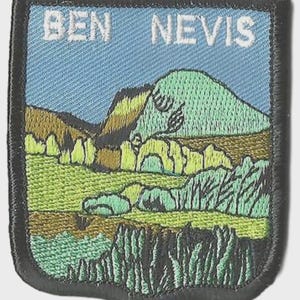 May include: Embroidered patch with the words "BEN NEVIS" above a landscape scene. The patch shows a mountain, trees, and fields in green, brown, and blue, with a black border.
