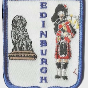 May include: Embroidered patch with a blue border featuring a lion statue and a Scottish bagpiper. The word "EDINBURGH" is vertically printed in blue. The patch is white with blue stitching.