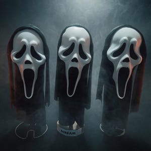 May include: Three white plastic masks with elongated black eye sockets and open mouths, each attached to a black fabric hood. The masks are mounted on individual stands, with the center base clearly displaying the word SCREAM in black letters.