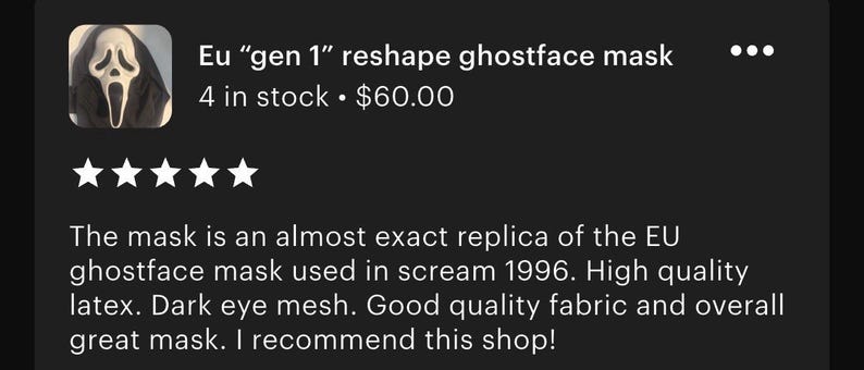 May include: A white latex Ghostface mask featuring a distorted, elongated facial expression with hollow black eye sockets and a wide, open mouth. The mask includes a black fabric hood attached to the top and sides, covering the head and neck area.