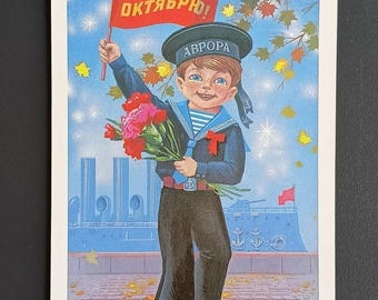 May include: Vintage illustration of a smiling boy in a sailor suit holding a bouquet of red flowers and a red flag with Cyrillic text. The boy wears a hat that says "AVRORA". The background features a ship and buildings.