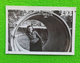 Vintage photo Pretty Girl posing in large pipe Smiling Woman