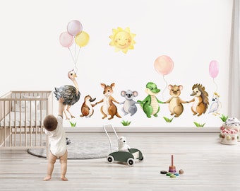May include: Watercolor wall decals featuring a cheerful sun, balloons, and a line of adorable animals including an ostrich, penguin, kangaroo, koala, crocodile, bear, hedgehog, and parrot. The decals are designed for a nursery or children's room.