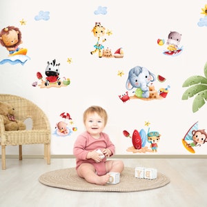 May include: A set of colourful animal-themed wall decals featuring a zebra, giraffe, lion, elephant, monkey, and hippopotamus enjoying summer activities like surfing, swimming, and building sandcastles. The decals are perfect for a child's bedroom or playroom.