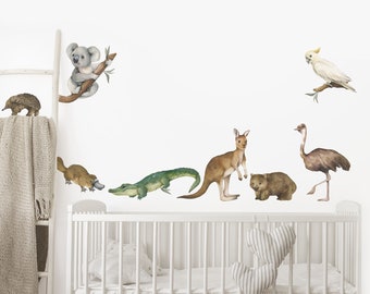 May include: A set of Australian animal wall decals featuring a koala, kangaroo, wombat, echidna, platypus, crocodile, emu, and cockatoo. The decals are printed in watercolor style and are perfect for a nursery or child's room.
