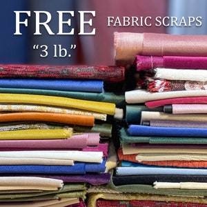 May include: A stack of colorful fabric scraps, free for the taking. The sign reads "FREE FABRIC SCRAPS "3 lb.""