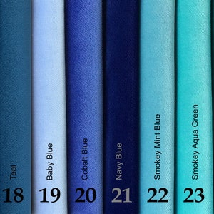 May include: A color palette of fabric swatches in shades of blue and green. The colors include black, teal, baby blue, cobalt blue, navy blue, smokey mint blue, smokey aqua green, and teal green. Each swatch is labeled with its color name and a number from 17 to 24.