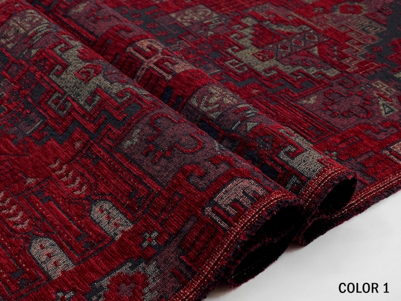 May include: A folded piece of fabric featuring a deep red base color with intricate geometric patterns in dark gray and black. The textile has a textured, woven appearance with the text COLOR 1 printed in the bottom right corner.
