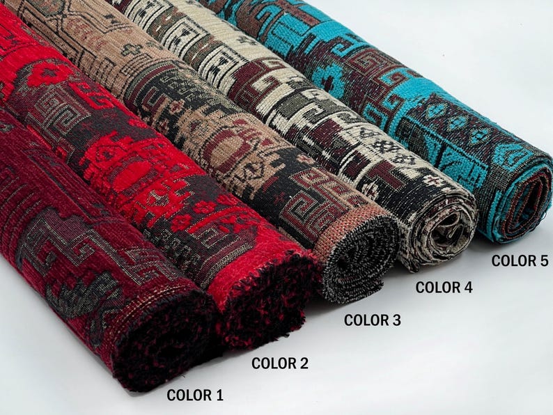 May include: Five rolled fabric bolts featuring a repeating geometric pattern. Color 1 is deep red, Color 2 is dark brown, Color 3 is black and white, Color 4 is dark maroon, and Color 5 is bright turquoise. Each bolt displays a distinct color scheme.
