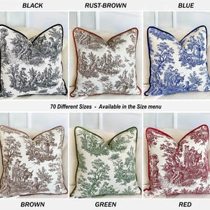 K&ouml;nnte beinhalten: Dekorative Zierkissen in verschiedenen Farben, darunter Schwarz, Rostbraun, Blau, Braun, Gr&uuml;n und Rot. Jedes Kissen zeigt ein detailliertes Toile-Muster mit einem kontrastierenden Rand. Der Text "70 Different Sizes - Available in the Size menu" ist ebenfalls zu sehen.