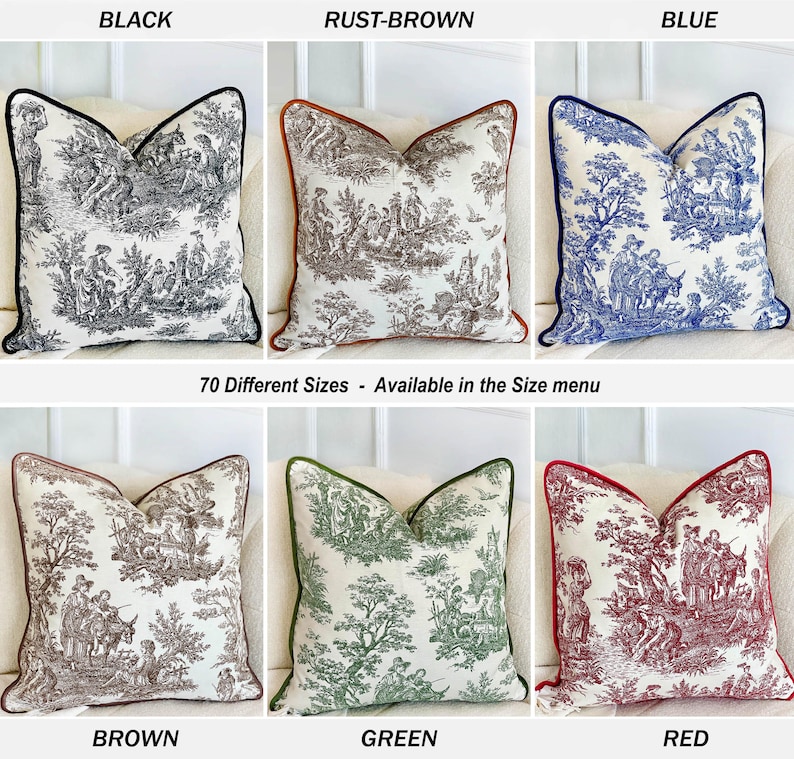 K&ouml;nnte beinhalten: Dekorative Zierkissen in verschiedenen Farben, darunter Schwarz, Rostbraun, Blau, Braun, Gr&uuml;n und Rot. Jedes Kissen zeigt ein detailliertes Toile-Muster mit einem kontrastierenden Rand. Der Text "70 Different Sizes - Available in the Size menu" ist ebenfalls zu sehen.
