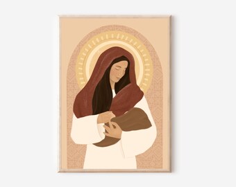May include: A framed art print depicts a woman in a white robe and a red head covering, cradling a baby. The background features a golden halo and a patterned archway, creating a serene and spiritual atmosphere. The artwork is framed in a light wood.