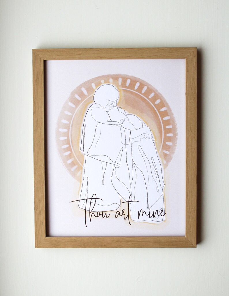May include: A framed art print featuring a minimalist line drawing of two figures embracing. The artwork is set against a soft, watercolor-style background with a circular design. The words "Thou art mine" are written in cursive.